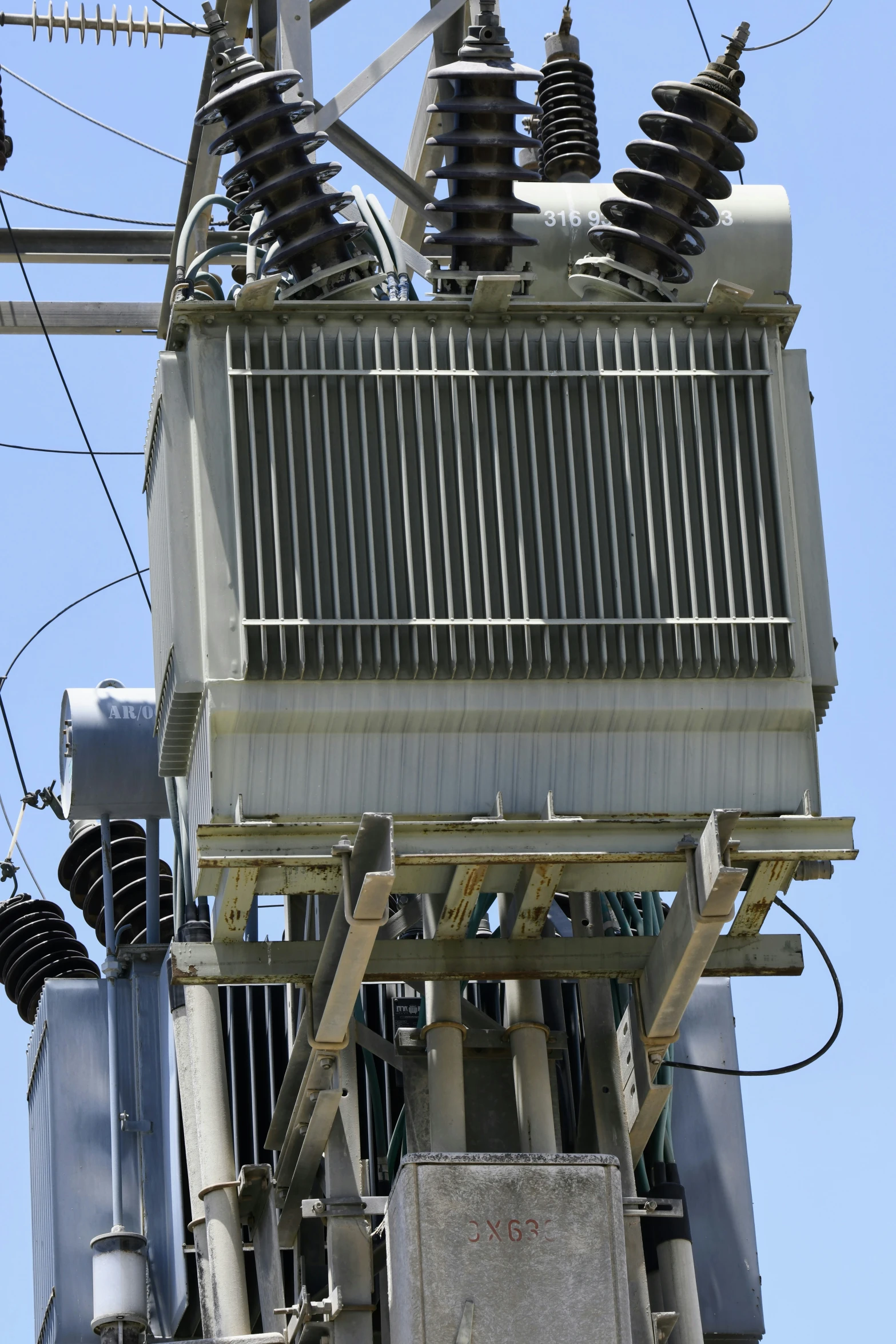 an electrical tower with power lines and wires