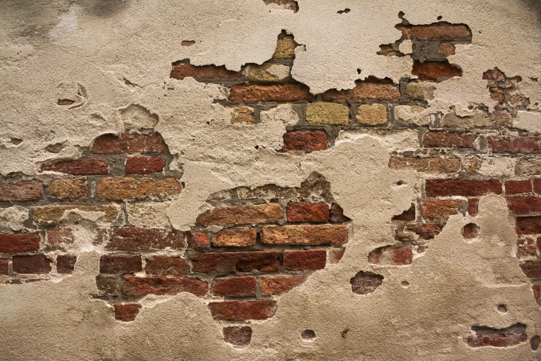 a close up of an old wall with red bricks