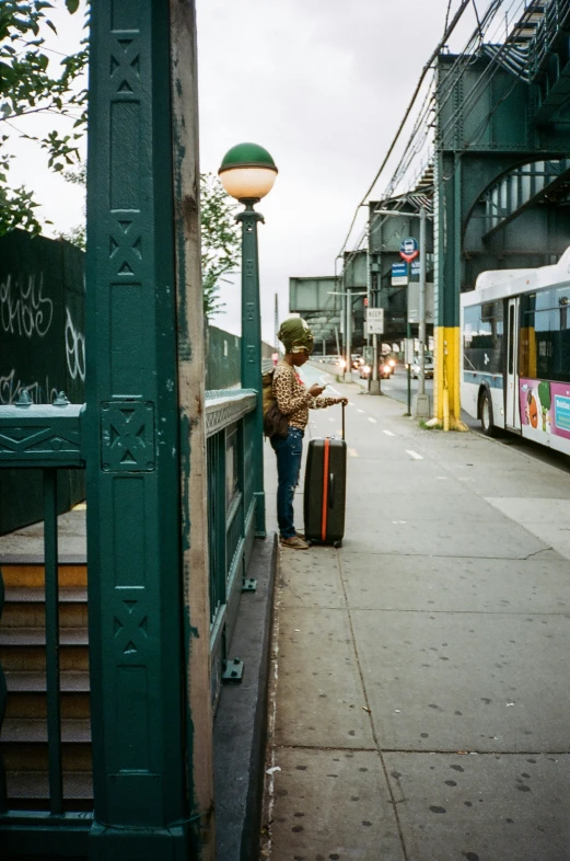 there is a man that is standing next to a street light