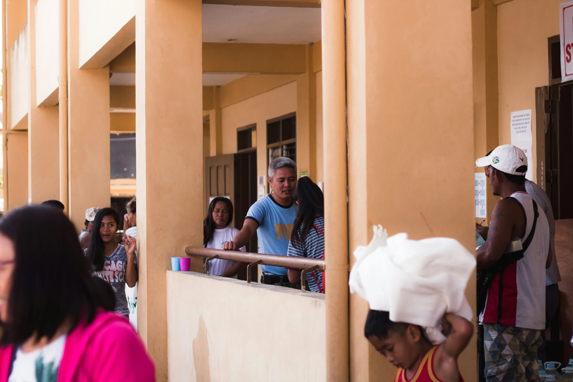 people lined up on a balcony to vote in the primary election