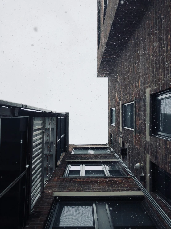 a building with lots of windows and snow on it