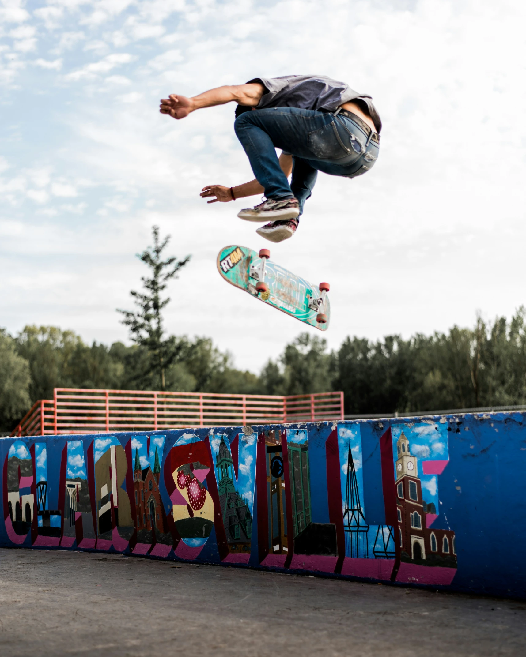 man doing skateboard trick with colorful graffiti in the air
