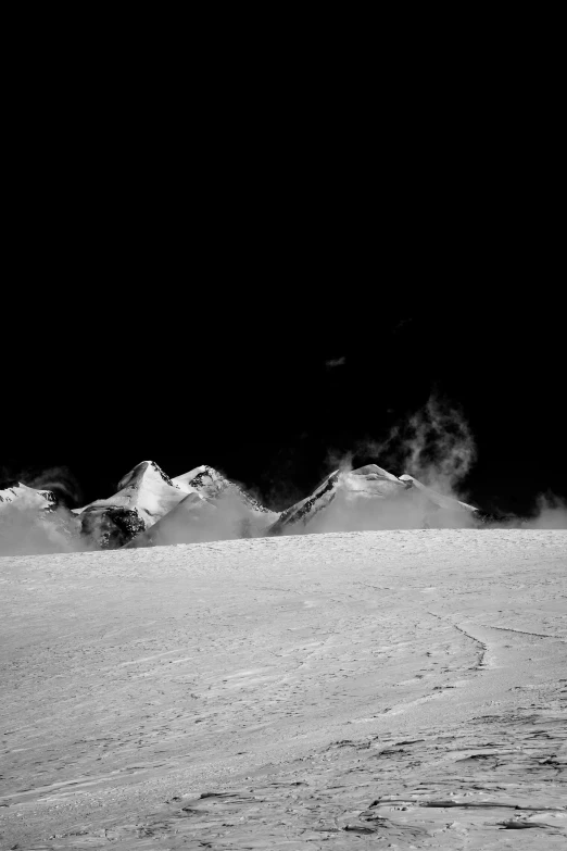 there is snow covered hills in the dark