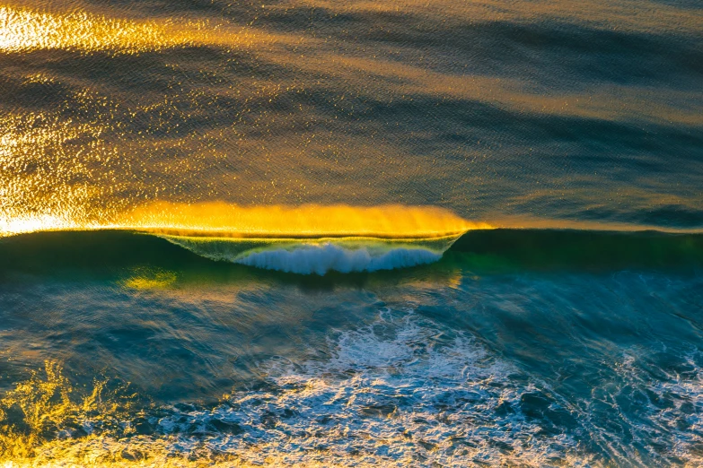 a po taken from above of a wave on a sunny day