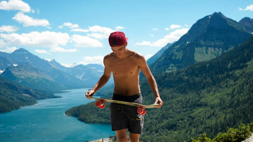 man holding rope above head while looking out on mountain