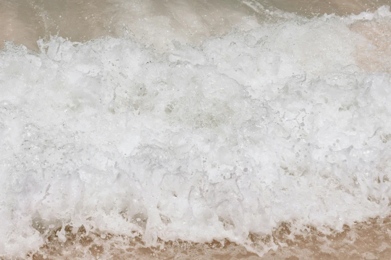 a large wave crashes on top of the beach