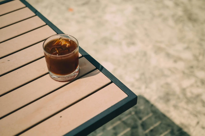 a brown drink sitting on top of a wooden table