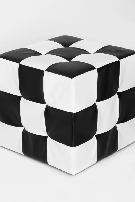 an ottoman made out of squares with black and white detailing