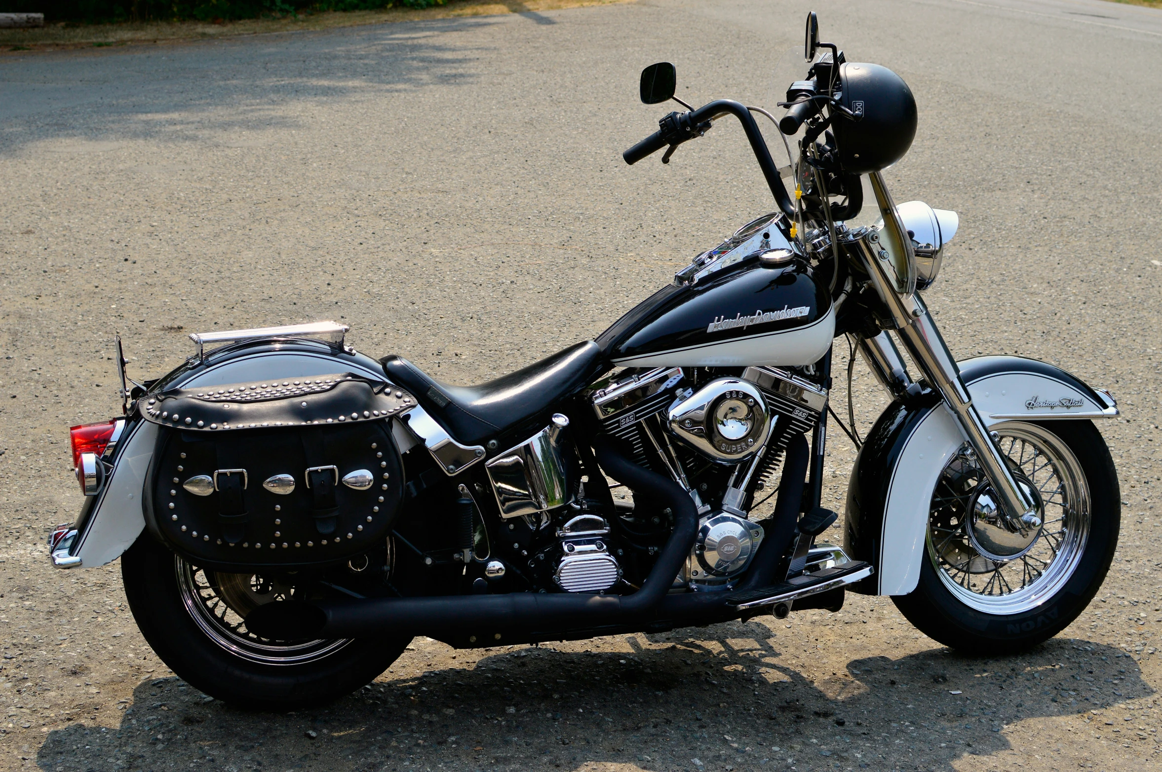 there is an old style motorcycle parked in the street