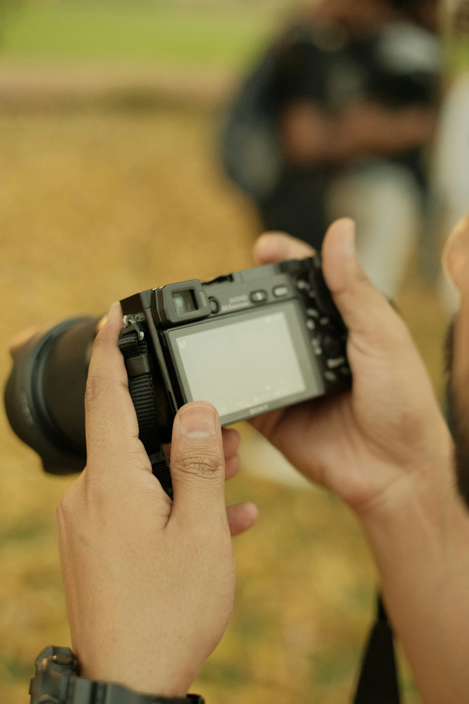 a close up of a person holding a camera