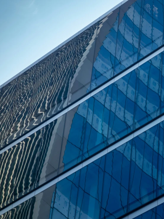 the top of a building with reflection on glass