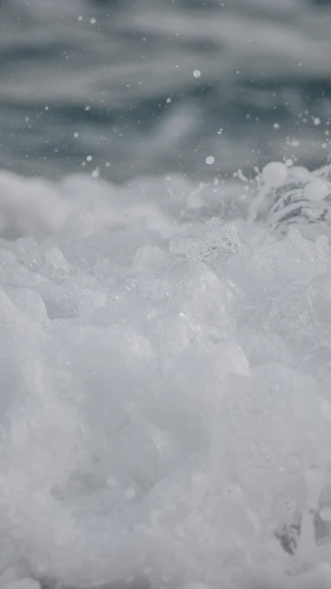 a small blue and white frisbee floating on water