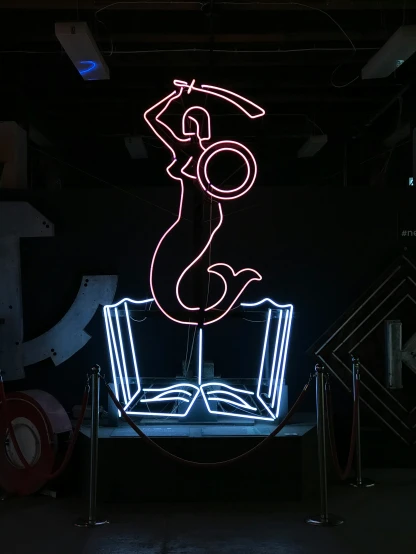 a large neon sign in the dark of night