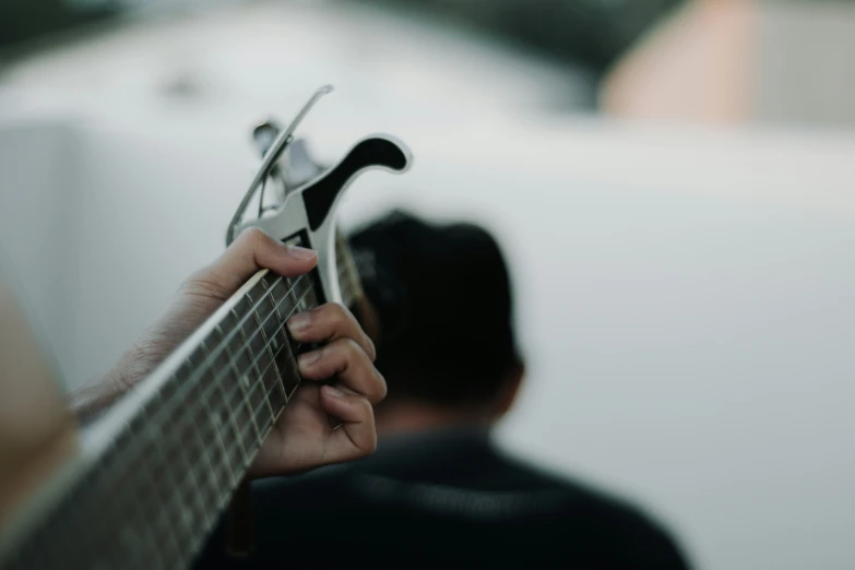 a man playing a guitar on stage during a show