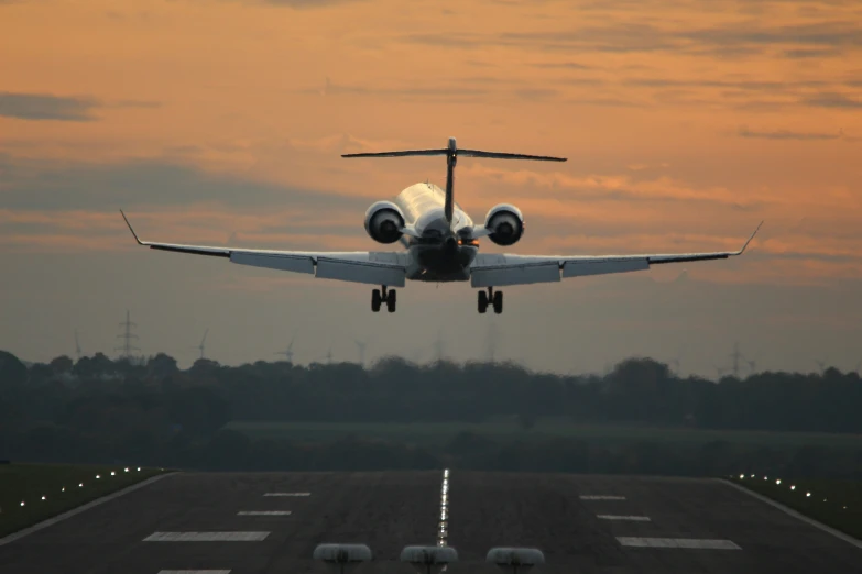 a propeller plane is making its way down an empty runway