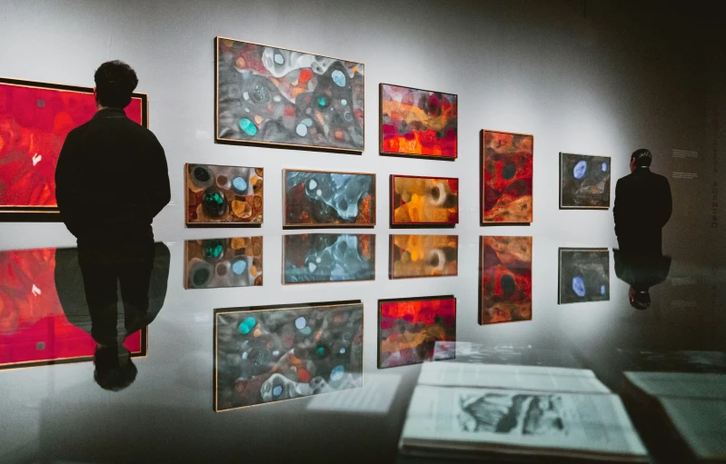 people admiring artwork on display at an art gallery