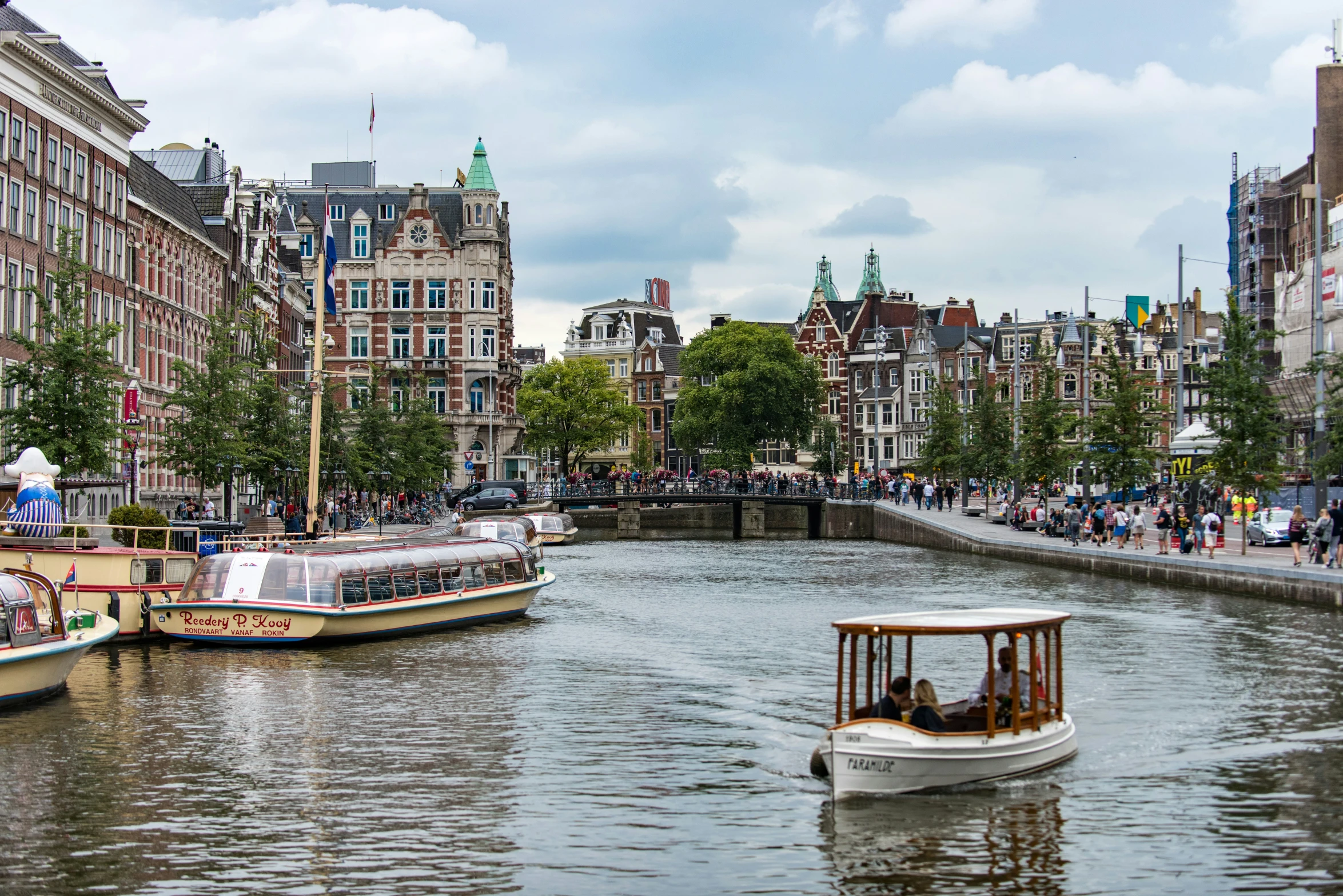 two boats on a body of water surrounded by buildings