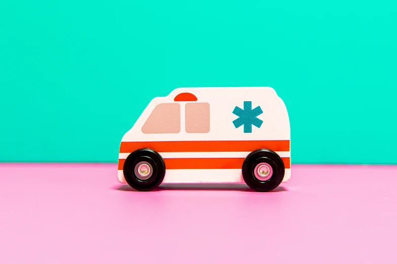 a white van with an orange striped roof sits on top of pink countertop