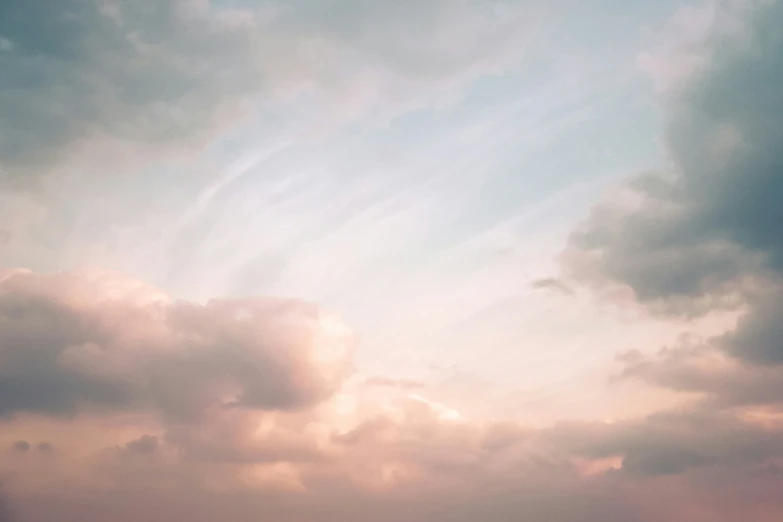 a plane flying in the sky on a cloudy day