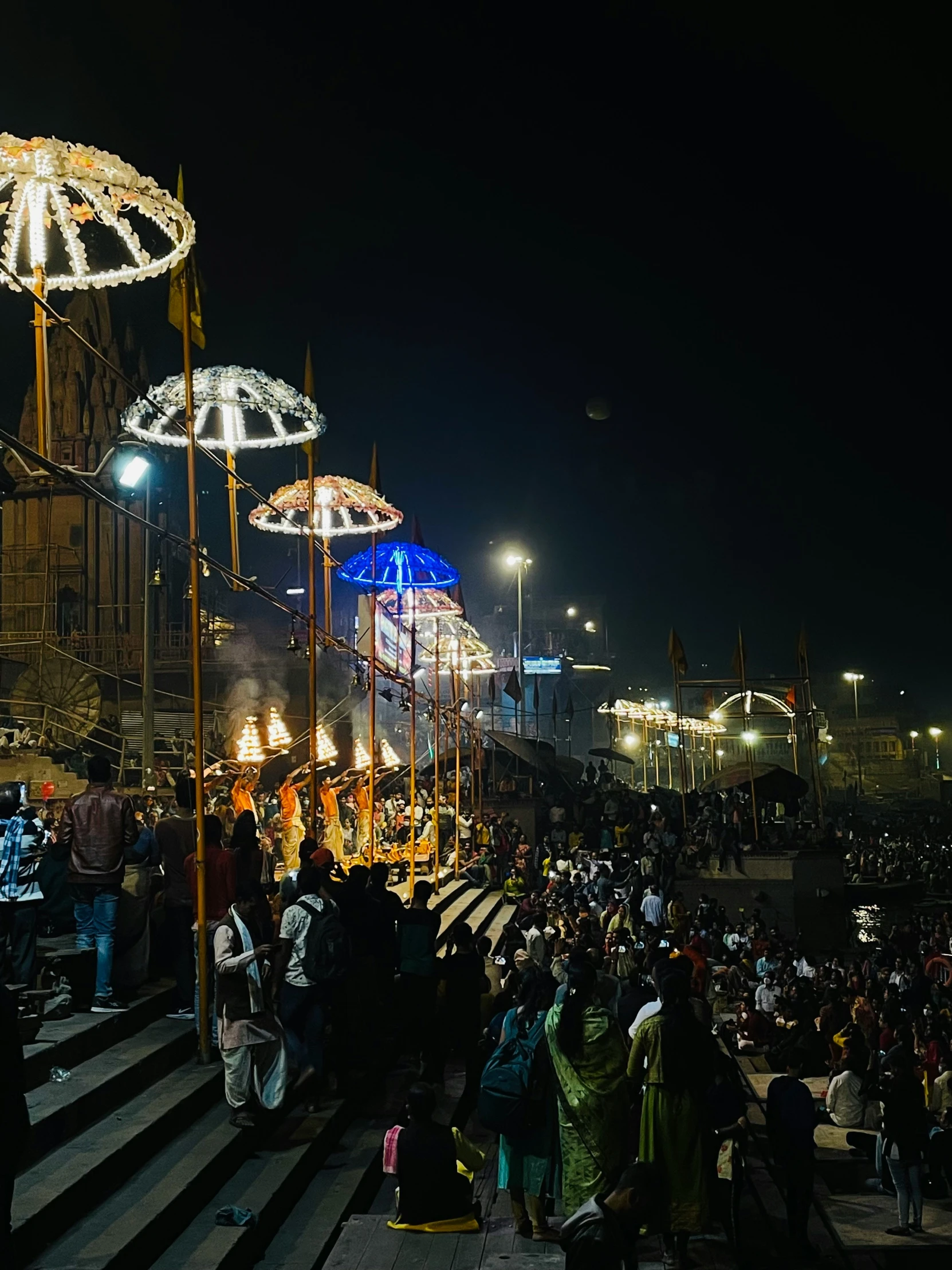 a festival with people walking through the area