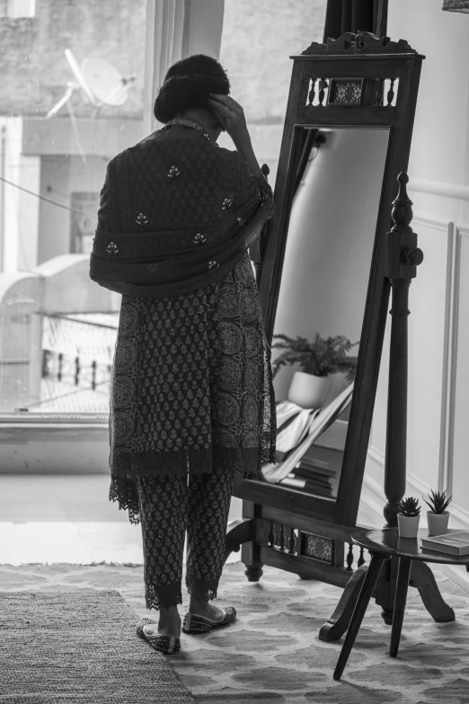 a woman taking a picture of herself in front of a mirror