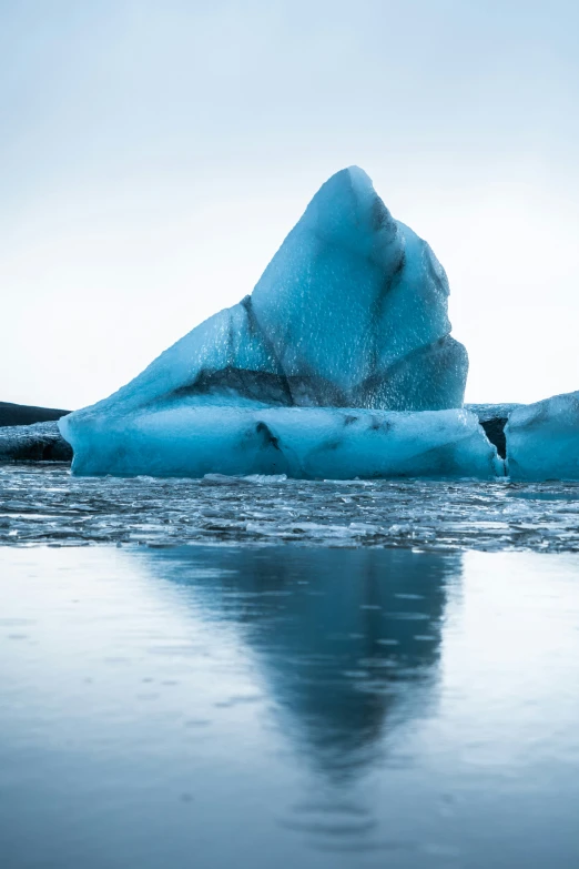 a large iceberg floats in the water