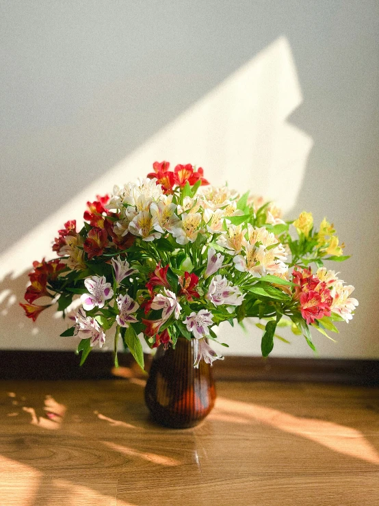 a wooden vase sitting on a table full of flowers