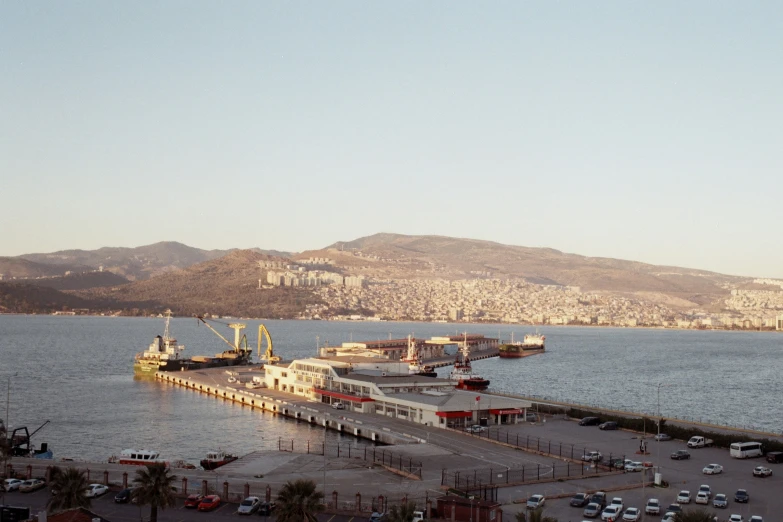 some vehicles on the side of a pier