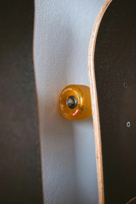 a close up of a yellow skateboard in the back