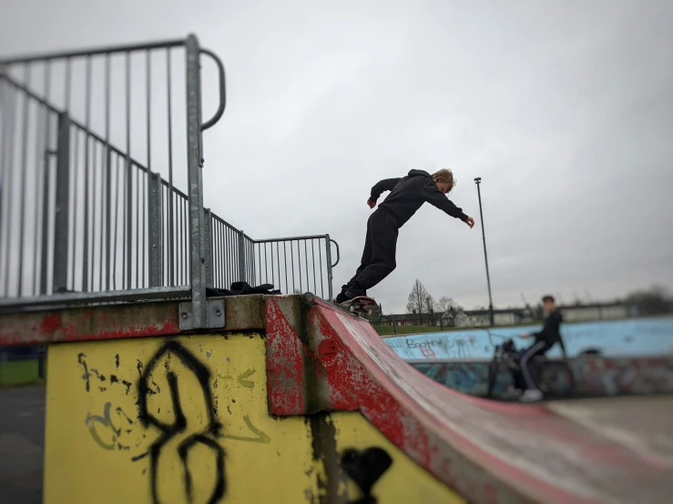 a person riding on a skateboard up a ramp