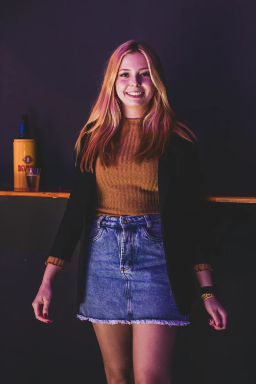 a young lady in a skirt posing for the camera