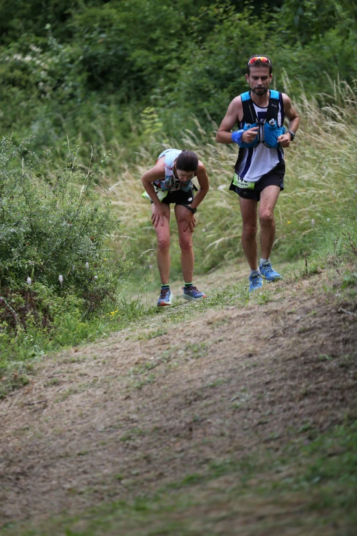 two people run in their underwear and backpacks