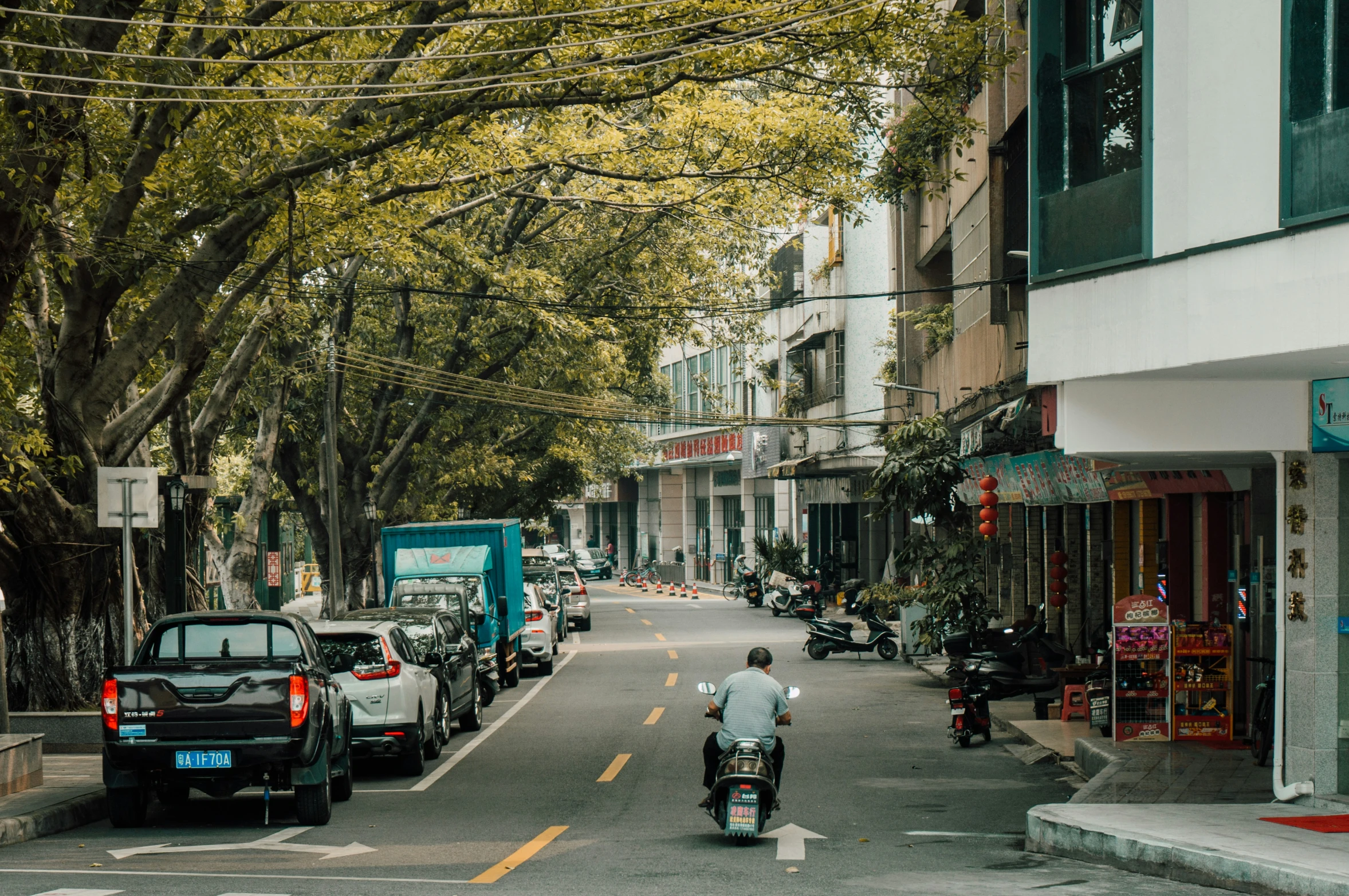 motorcycles and cars on a busy city street