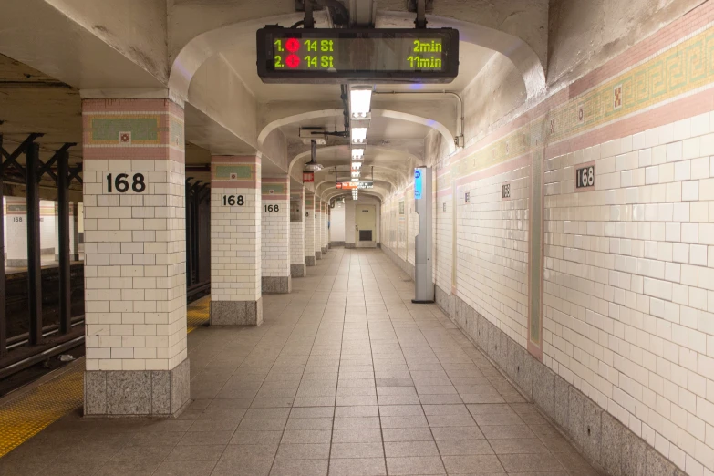 a subway station has a red light and an electronic sign