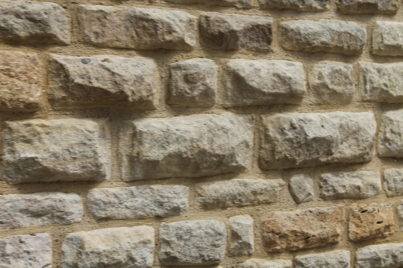 a closeup of an old wall with several pieces of rock