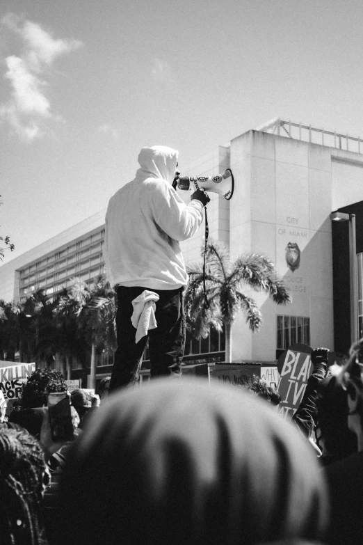 man standing on stage while holding a microphone