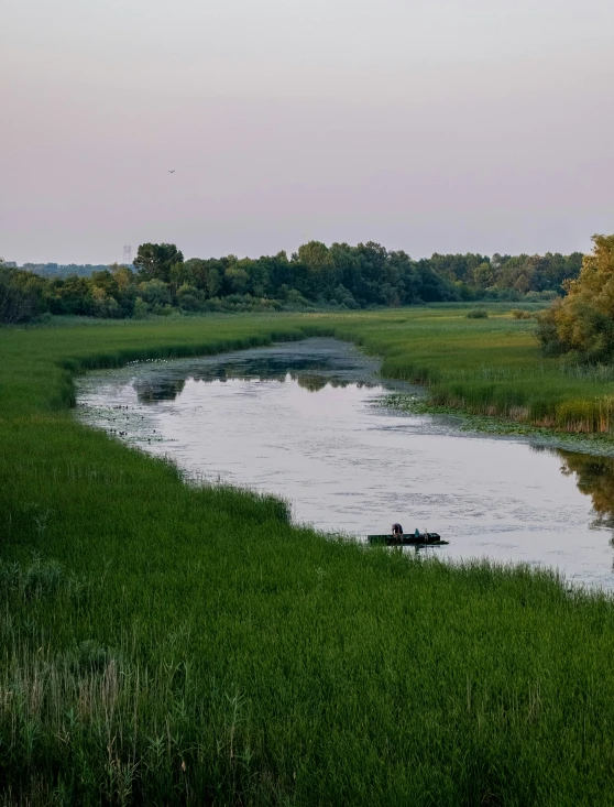 a man is riding on a boat in a lake