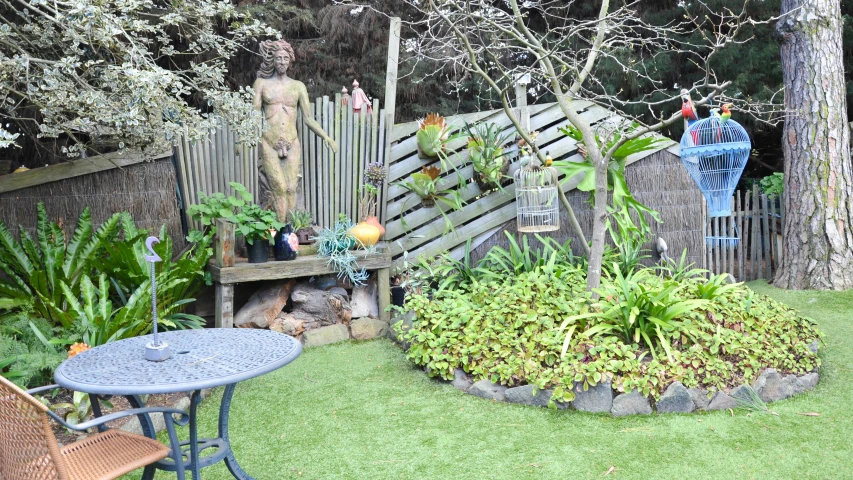 an outdoor garden with tables and chairs and lots of plants