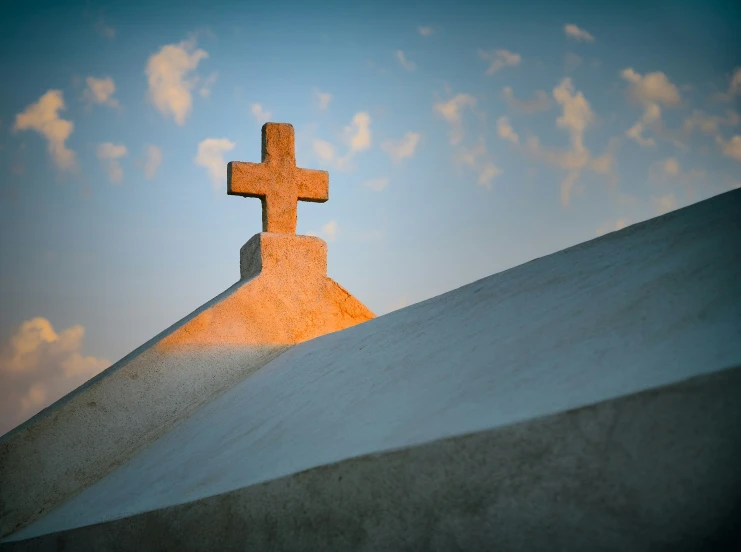 the cross on top of the hill with a sky background