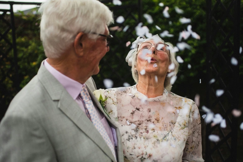 a man and woman dressed in old fashioned clothing are smiling for a picture