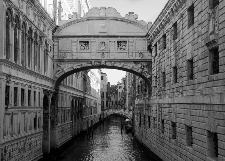 a long canal flowing under an old bridge