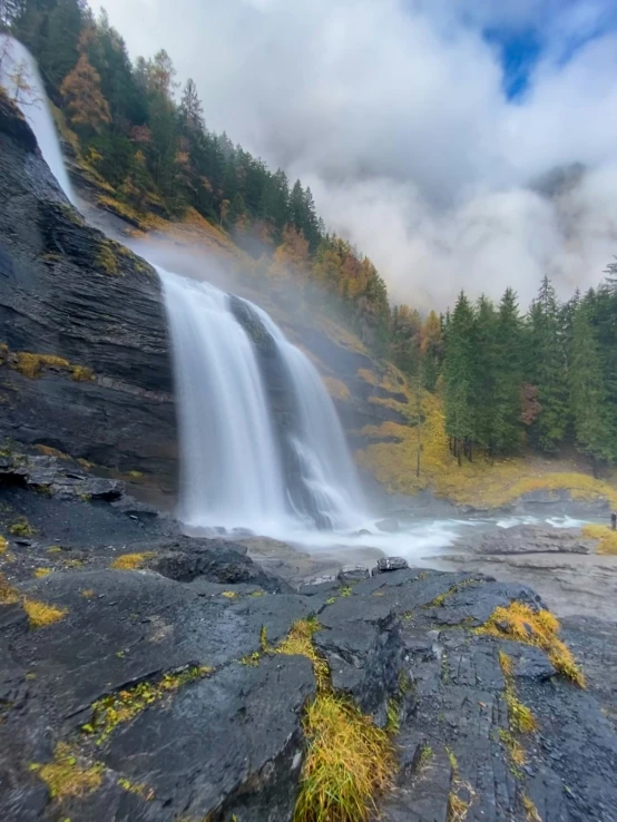 a waterfall in the middle of a forest