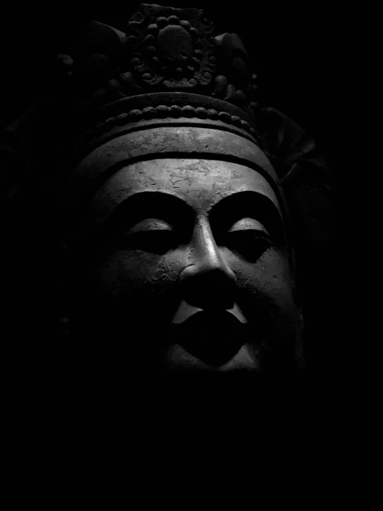 black and white image of an buddha head