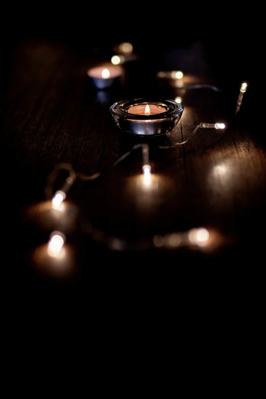 some lit candles are laying on the table