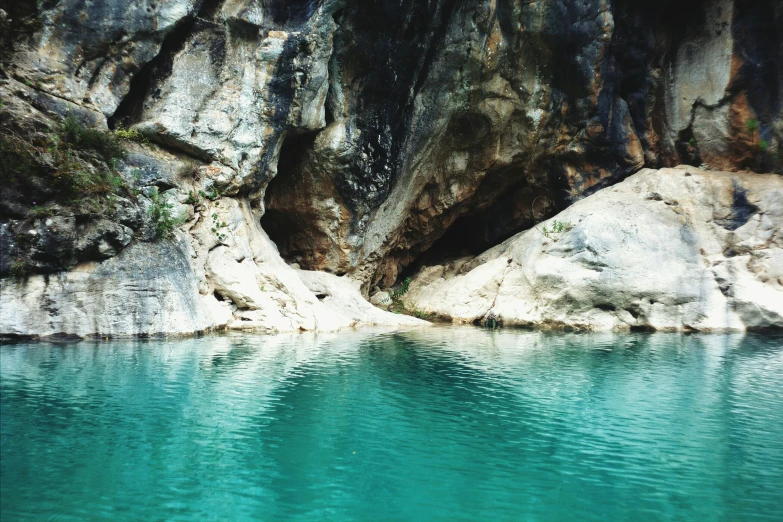 a body of water in front of some mountains