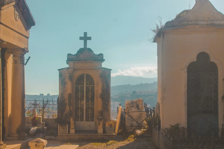 some very old buildings and a large cross