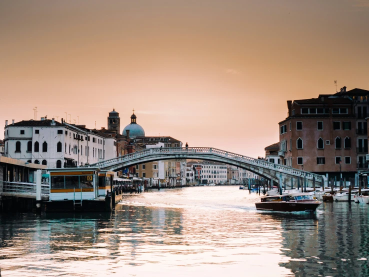 a narrow, empty waterway with people and boats floating on it