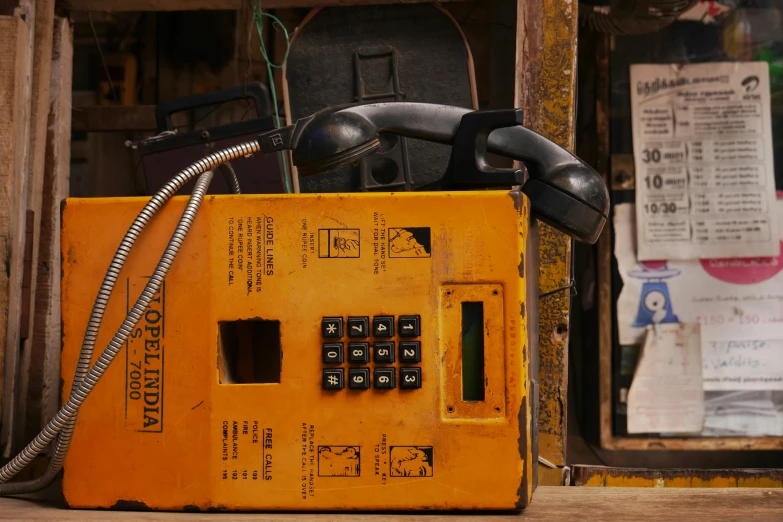 a phone is next to some parts of an old fashioned telephone