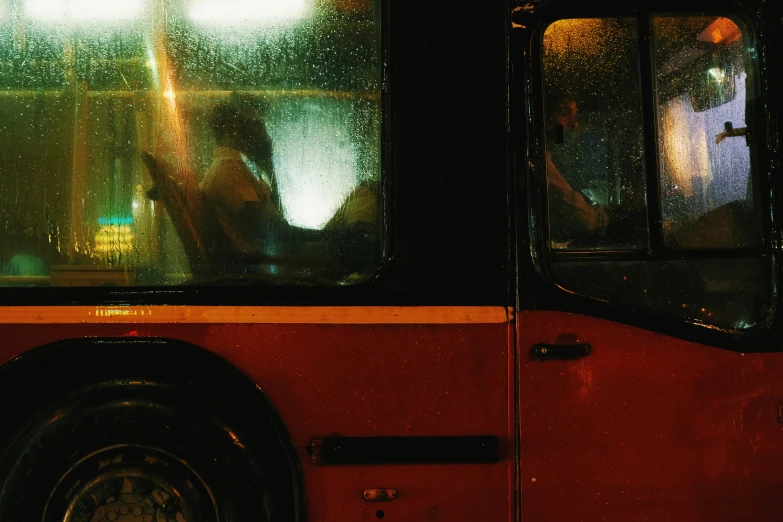 people inside a bus on a rainy day