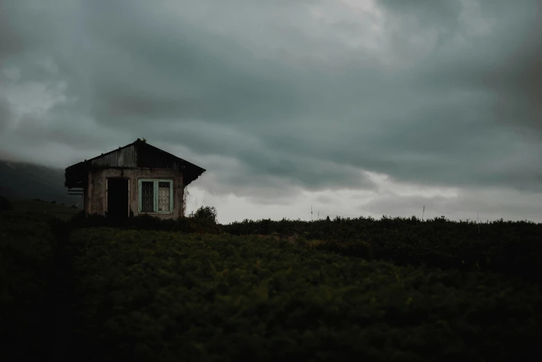 an old house stands out among the hills